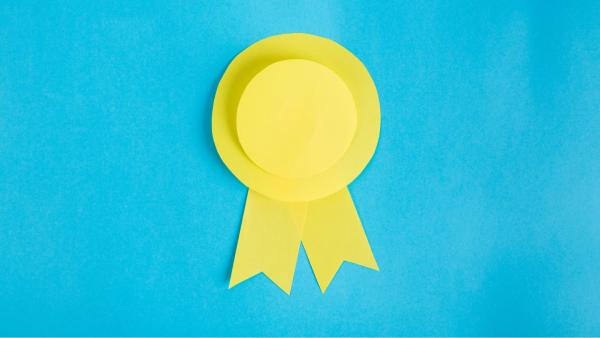 A yellow ribbon award on a light turqouise background