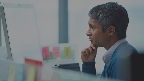 Person working on computer thinking