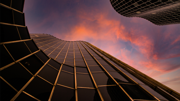 Looking up a skyscraper at clouds