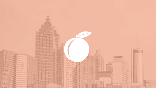 Peach symbol over a peach colored skyline of Atlanta