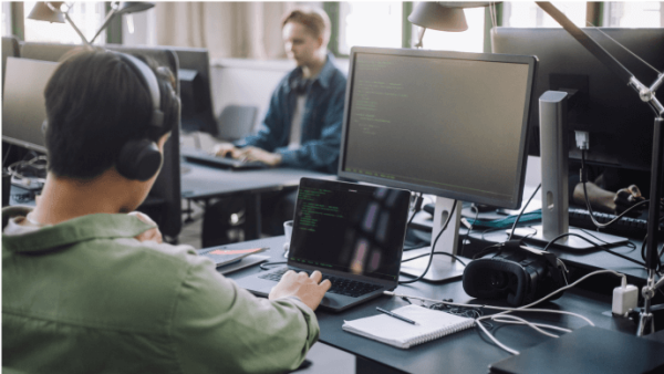 Individuals working on computers at their desk